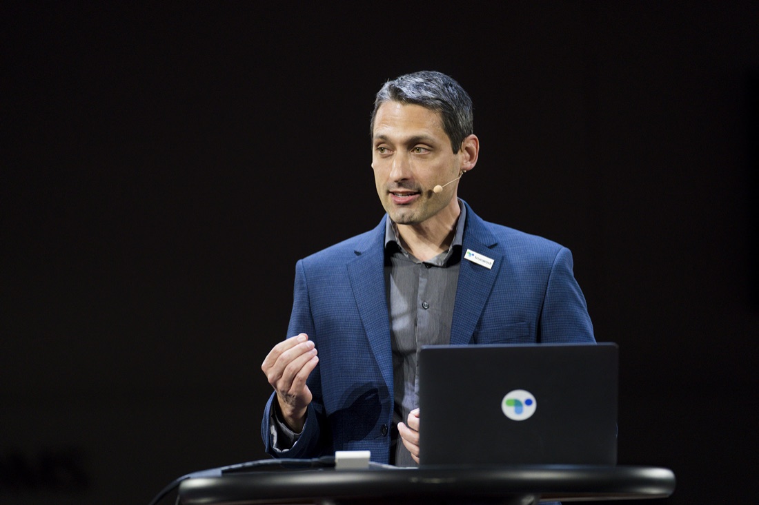 Adam Kerin presenting on stage at a Truework event